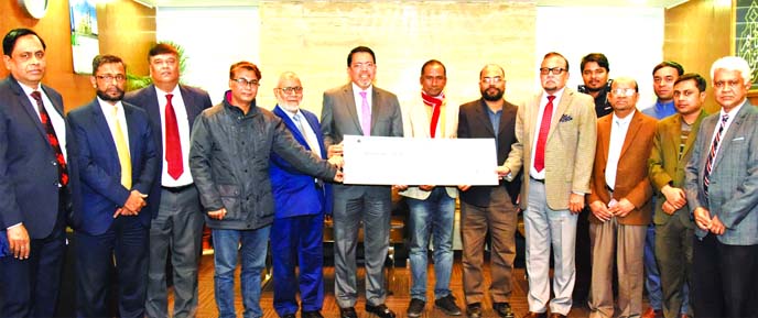 R. Chowdhury, CEO of Al-Arafah Islami Bank Limited, handing over a cheque of said amount to Rafiqul Islam Azad, President and Ilias Hossain, former President of Dhaka Reporters Unity (DRU) for constructing a new motorcylce stand at their premises at the b