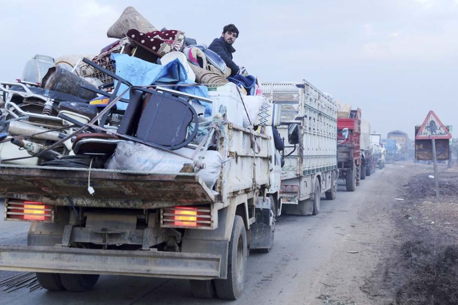A man rides in a truck as civilians flee a Syrian military offensive in Idlib province on the main road near Hazano, Syria on Tuesday.