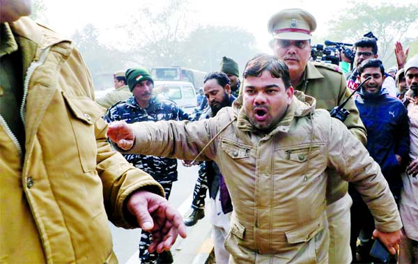 Police detain a demonstrator during a protest against a new citizenship law, in front of Uttar Pradesh state bhawan (building) in New Delhi on Thursday.
