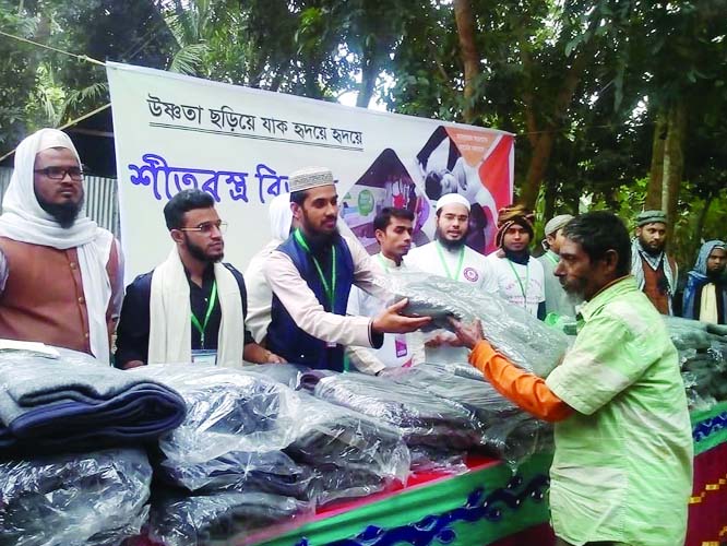 GAFARGAON (Mymensingh) : Executives of BD Artosheba Foundation distributing blankets among the cold-hit distressed people at Charsakhasura village in the upazila recently.