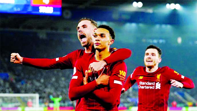 Liverpool's Trent Alexander-Arnold (left) celebrates scoring their fourth goal with Jordan Henderson and Andrew Robertson against Leicester during the Premier League match at King Power Stadium in Leicester of Britain on Thursday.