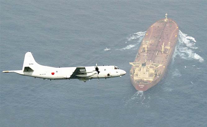 a P-3C anti-submarine patrol plane of the Japan Maritime Self-Defense Force (JMSDF) flies after dropping anti-submarine bombs during the official triennial JMSDF fleet review in the waters off Sagami Bay, south of Tokyo. Japan on Friday.