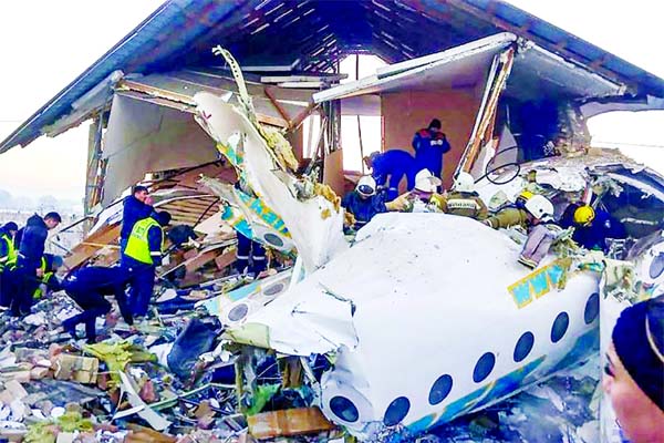 Rescuers working at the site of a passenger plane crash outside Almaty.