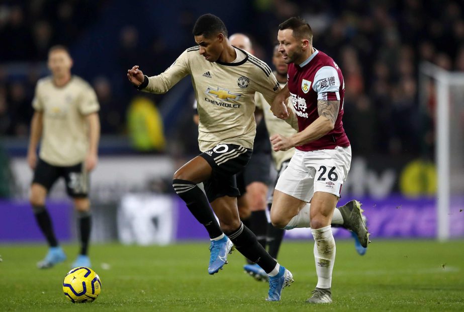 Manchester United's Marcus Rashford (left) and Burnley's Phil Bardsley battle for the ball during the English Premier League soccer match at Turf Moor, Burnley, England on Saturday.