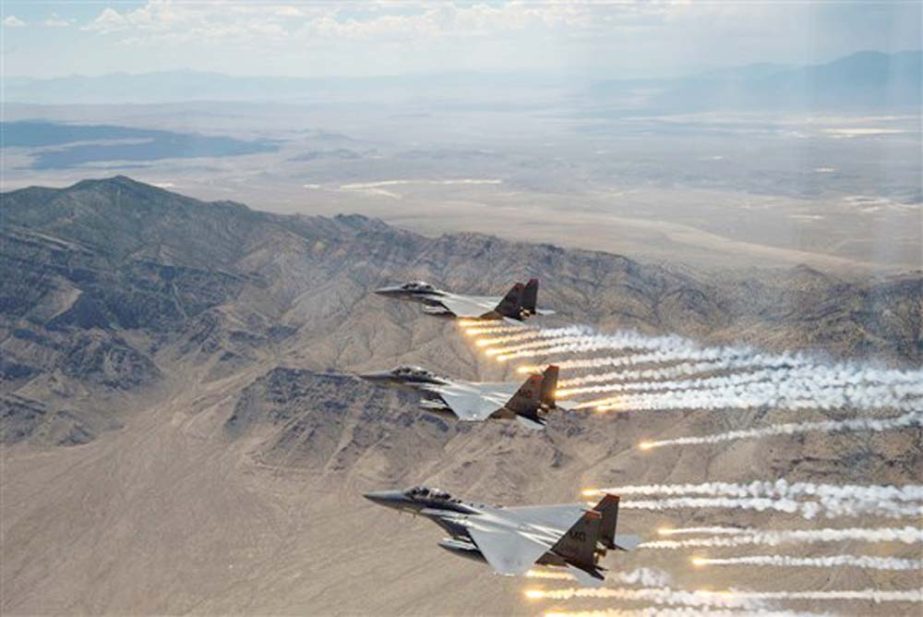 Air Force F-15E Strike Eagles, pictured firing flares over the Utah Test and Training Range in July 2018, dropped precision-guided bombs in Iraq and Syria on Saturday afternoon, Defense Secretary Mark Esper said.