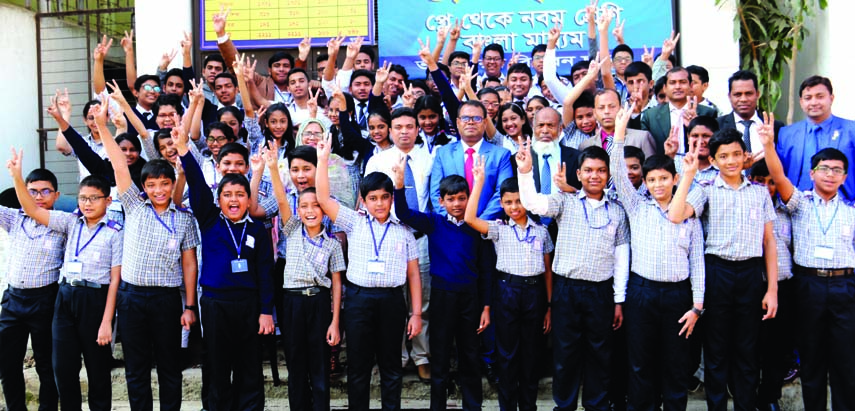 Students along with teachers of the city's Milestone School and College rejoicing with victory (V) sign on its campus on Tuesday for brilliant results in PEC and JSC examinations.