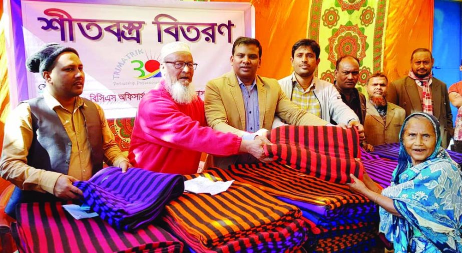 KURIGRAM: Md Jahnagir Alam, Additional Deputy Police Commissioner of DMP and President of Trimatrik 30- BCS Officers' Cooperative Society distributing winter clothes among the cold- hit people at Nageshwari Upazila on Monday.