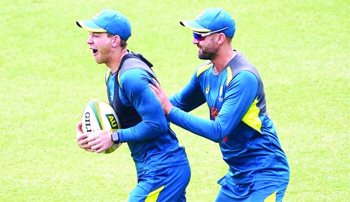 Tim Paine ( left) and Nathan Lyon play a game of rugby during practice before the Australia v New Zealand Test in Sydney on Wednesday.