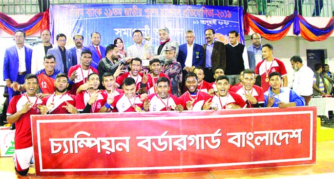 Members of Border Guard Bangladesh (BGB) team, the champions in the EXIM Bank 29th National Men's Handball Competition with the guests and officials of Bangladesh Handball Federation pose for photograph at the Shaheed (Captain) M Mansur Ali Nationa