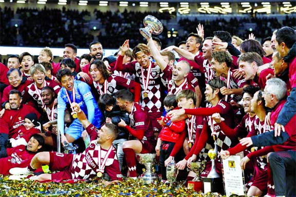 Vissel Kobe's Andres Iniesta (center right) holding trophy with teammates celebrate as their team won the Emperor's Cup soccer final against Kashima Antlers at the National Stadium in Tokyo on Wednesday.