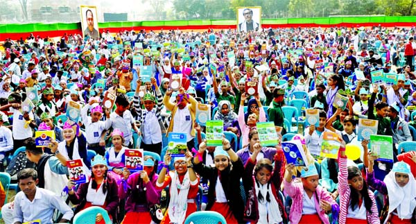 Book distribution celebration 2020: Thousands of primary students rejoicing with new books on the first day of the new year 2020, organised by Primary and Mass-education Ministry at DU central playground on Wednesday.
