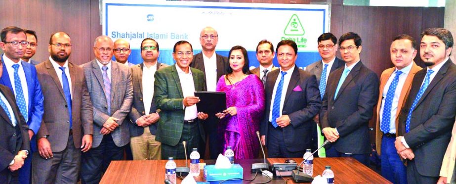 M. Shahidul Islam, CEO of Shahjalal Islami Bank Limited and Adeeba Rahman, CEO of Delta Life Insurance Company Limited, exchanging document after signing an agreement at the bank's corporate head office in the city recently. Under the deal, all employees