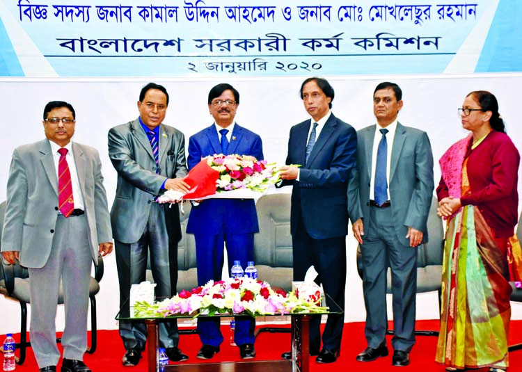Chairman of Bangladesh Public Service Commission Dr Mohammad Sadik accords farewell reception to two members of the commission Kamal Uddin Ahmed and Mokhlesur Rahman giving bouquets in the auditorium of the commission in the city on Thursday.