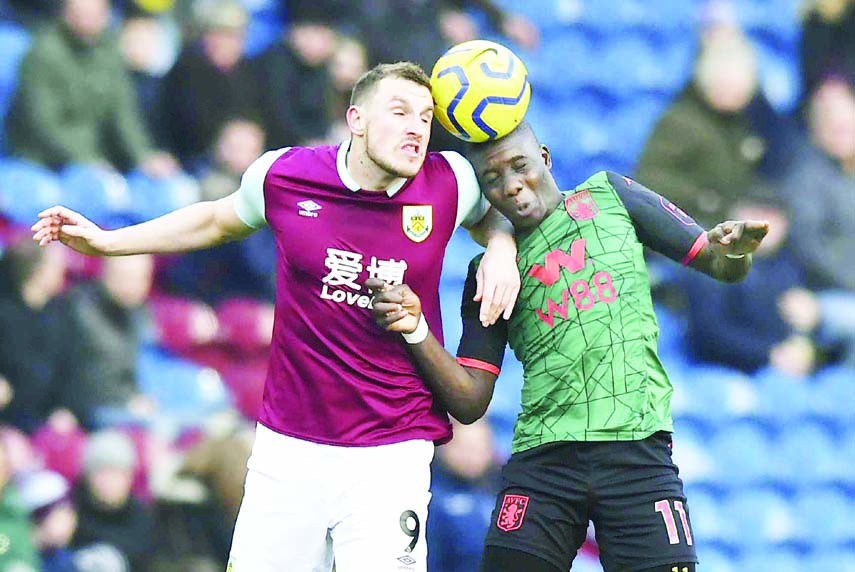 Burnley's Chris Wood (left) and Aston Villa's Marvelous Nakamba battle for the ball during the English Premier League soccer match between Burnley and Aston Villa, at Turf Moor in Burnley of England on Wednesday.