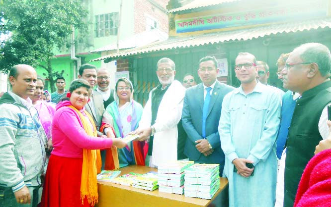 NAOGAON: Upazila Chairman and General Secretary of Upazila Awami League Alhaj Sirajul Islam Khan Raju distributing books among the autistic students at Adamdighi Upazila on Thursday.