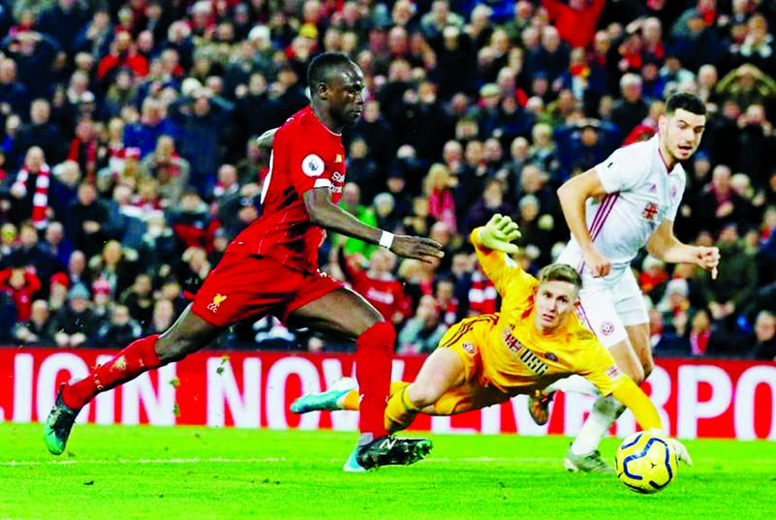 Liverpool's Sadio Mane (left) scores their second goal during the Premier League match between Liverpool and Sheffield United, at Anfield in Liverpool of Britain on Thursday.