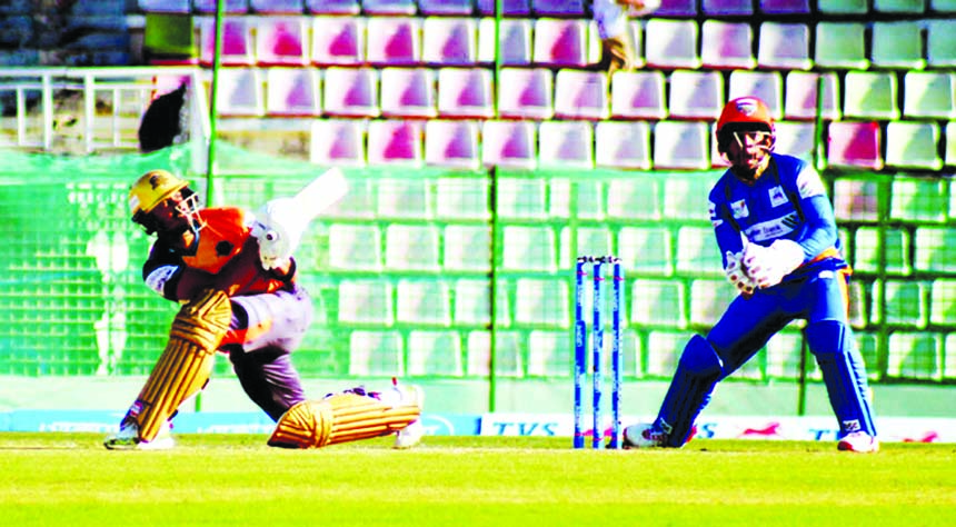 Asif Ali of Dhaka Platoon, plays a shot, while wicketkeeper Mushfiqur Rahim of Khulna Tigers looks on during the Twenty20 cricket match of the Bangabandhu Bangladesh Premier League at Sylhet International Cricket Stadium on Friday.