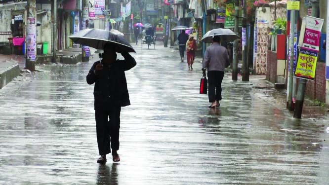 BARISHAL: People are using umbrella in Barishal city as rain disrupted normal life yesterday.