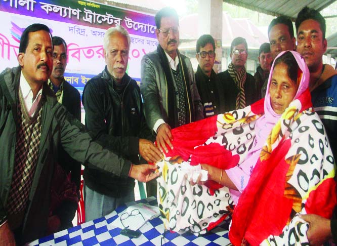 MADHUKHALI(Faridpur): Leaders of Rupali Kalyan Trust distributing winter clothes among the poor people at Madhukhali Upazila on Thursday.