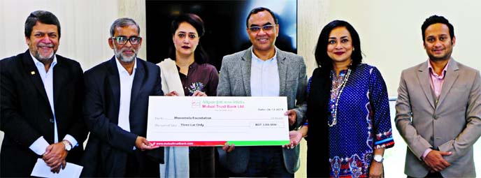 Syed Mahbubur Rahman, CEO of Mutual Trust Bank Limited (MTB), handing over a cheque of Tk 300,000 to Md. Abdur Rahim, founder of Monomela Foundation, at the bank's head office in the city recently to support their endeavors such as free after-school educ