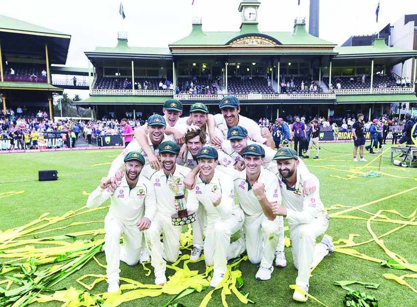 Australian captain Tim Paine and team mates with the Trans-Tasman Trophy after winning the test match and series on day four of the third cricket test match between Australia and New Zealand at the Sydney Cricket Ground, Sydney, Australia on Monday.