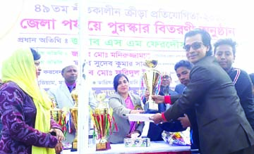 Physical Education Teacher of Singair Government High School and former national athlete Md Altaf Hossain receiving the champions trophy of the Cricket Competition of the Annual Sports Competition of Bangladesh National School, Madrasa and Technical Educa