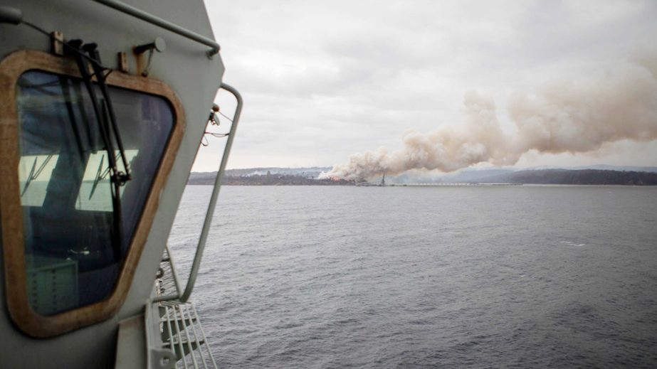 A fire burns near Eden as HMAS Adelaide arrives to assist with wildfires. The wildfires have so far scorched an area twice the size of the U.S. state of Maryland. AP file photo