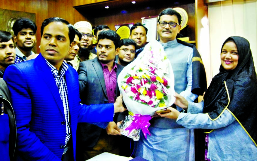 State Minister for Shipping Khalid Mahmud Chowdhury being greeted with bouquets by the officials and employees of the ministry at his office on Tuesday marking one year of AL Government.