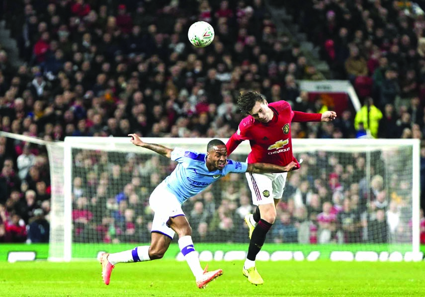 Manchester City's Raheem Sterling (left) vies for the ball with Manchester United's Victor Lindelof during the English League Cup semifinal first leg soccer match between Manchester United and Manchester City and at Old Trafford in Manchester of Englan