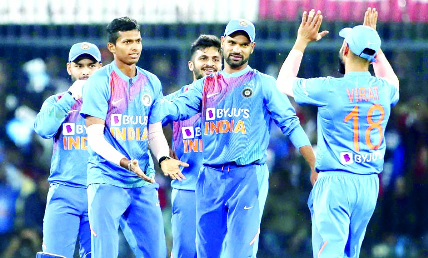 India's Navdeep Saini (second left) celebrates with teammates the dismissal of Sri Lanka's Danushka Gunathilaka during the second Twenty20 international cricket match between India and Sri Lanka, in Indore of India on Tuesday.