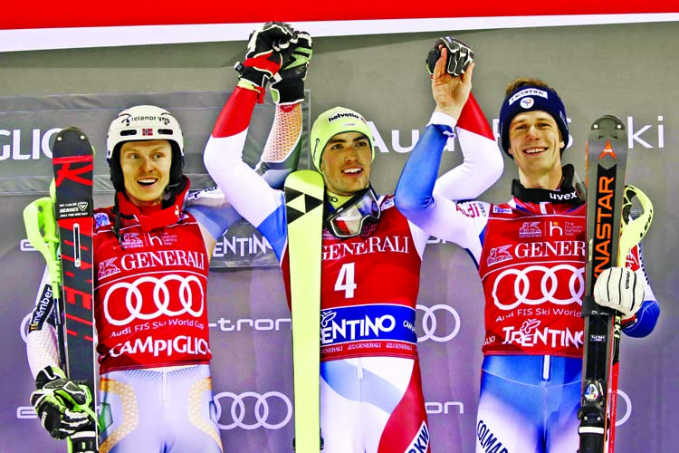 From left, second placed Henrik Kristoffersen of Norway, winner Daniel Yule of Switzerland and third placed Clement Noel of France celebrate on the podium of an alpine ski, men's World Cup slalom in Madonna di Campiglio, Italy on Wednesday.