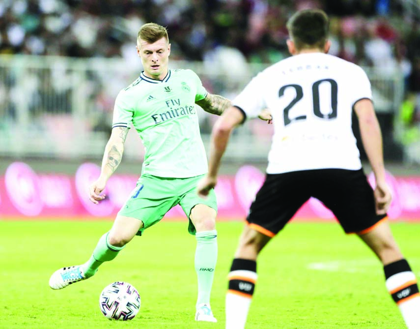 Real Madrid's Toni Kroos shoots the ball during the Spanish Super Cup semifinal soccer match between Real Madrid and Valencia at King Abdullah stadium in Jeddah of Saudi Arabia on Wednesday.
