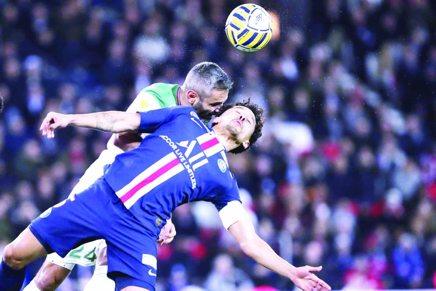 PSG's captain Marquinhos (right) challenges to head the ball with Saint Etienne's captain Loic Perrin during the French League Cup quarter final soccer match between Paris Saint Germain and Saint Etienne at the Parc des Princes stadium in Paris on Wedn