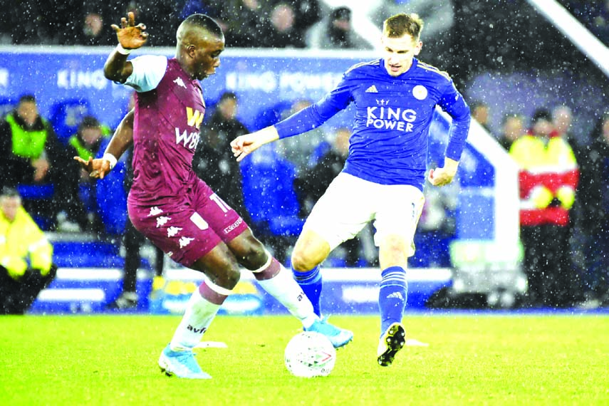 Aston Villa's Marvelous Nakamba (left) is challenged by Leicester's Marc Albrighton during the English League Cup semifinal first leg soccer match between Leicester City and Aston Villa at the King Power Stadium in Leicester of England on Wednesda