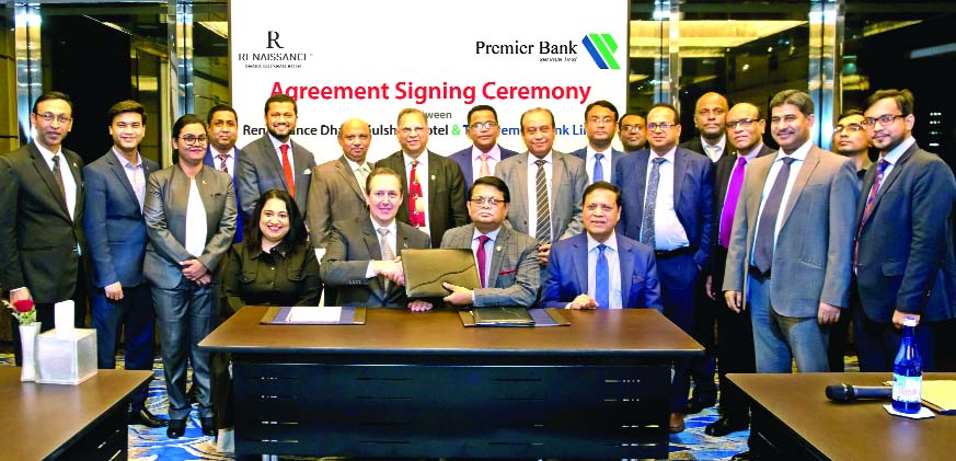 M. Reazul Karim, Managing Director & CEO of Premier Bank Limited and Jerome Lienart, General Manager of Renaissance Dhaka Gulshan Hotel, exchanging documents after signing an agreement at the hotel in the city on Wednesday. Bank's Advisor Muhammed Ali, A