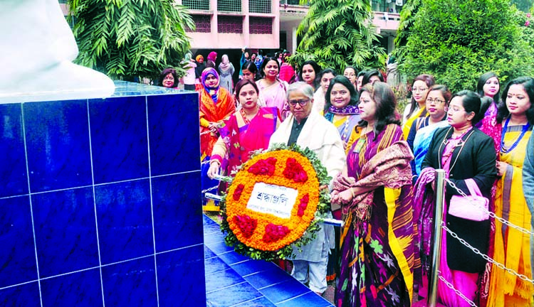 Dhaka University Vice-Chancellor Prof Dr Akhtaruzzaman placing wreaths at the portrait of Begum Rokeya at Begum Rokeya Hall of DU on Saturday marking Rokeya Day.