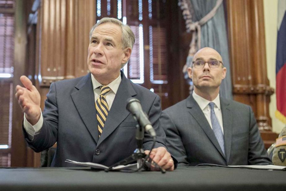 Gov. Greg Abbott, left, speaks at a news conference at the Capitol, in Austin, Texas. Abbott says the state will reject the re-settlement of new refugees, becoming the first state known to do so under a recent Trump administration order.