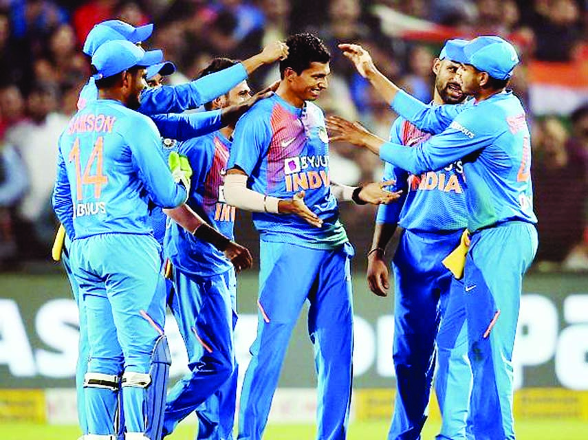 Indian bowler Navdeep Saini celebrates with teammates after dismissal the wicket of Sri Lankan batsman Kusal Perera during the third T20 cricket match against Sri Lanka and India at Maharashtra Cricket Association Stadium in Pune on Friday.