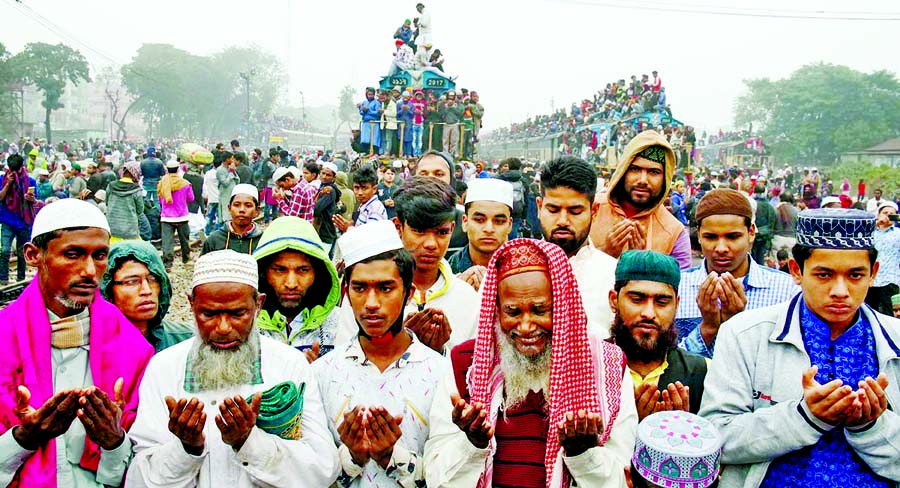 Thousands of devotees offering Munajat for the divine blessings of Muslim Ummah at the 1st phase of Bishwa Ijtema ground in Tongi on Monday.