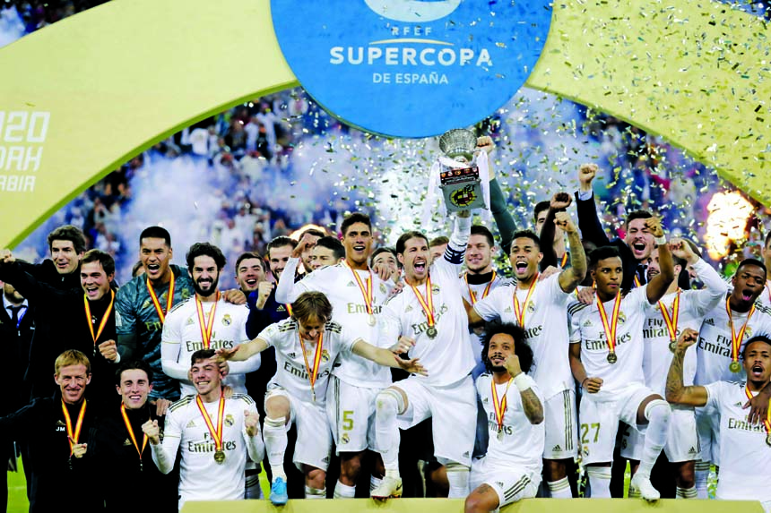 Real Madrid's Sergio Ramos holds up the trophy, at the end of the Spanish Super Cup Final soccer match between Real Madrid and Atletico Madrid at King Abdullah stadium in Jeddah of Saudi Arabia on Sunday.