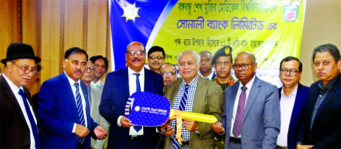 Ziaul Hasan Siddiqui, Chairman along with Md. Ataur Rahman Prodhan, CEO of Sonali Bank Limited, handing over the key of an AC bus to Professor Dr Kanak Kanti Barua, Vice-Chancellor of Bangabandhu Sheikh Mujib Medical University (BSMMU) on Monday. High off