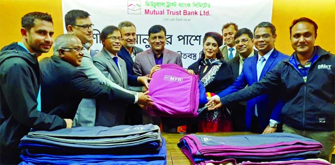 Amitav Kaiser, Head of Infrastructure Division of Mutual Trust Bank Limited (MTB), handing over blankets to Capt. (Retd) Muhammad Alamgir, President of Cadet College Club Limited (CCCL) for distribution among the cold-affected people through the CCCL auth