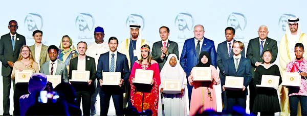 Prime Minister Sheikh Hasina poses for a photo session with the winners of 'Zayed Sustainability Prize' at the ICC Hall in Abu Dhabi National Exhibition Centre on Monday.