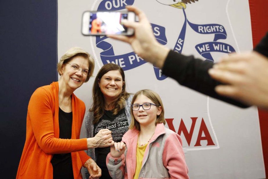 Democratic Presidential candidate Sen. Elizabeth Warren, D-Mass. (left), poses for a photo session with attendees after speaking at a campaign event on Sunday in Marshalltown, Iowa.