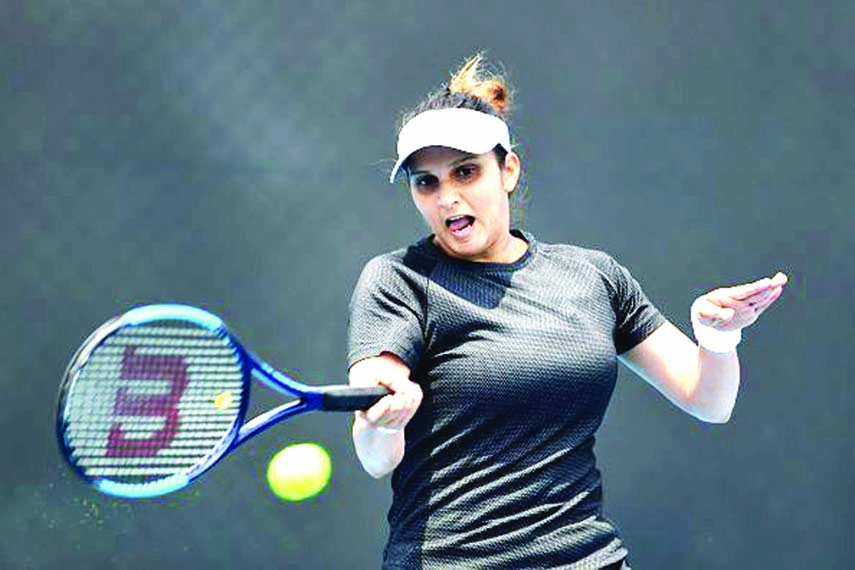 Sania Mirza hits a return during her match at the Hobart International Tournament with Ukrainian partner Nadia Kichenok, in Hobart on Tuesday.