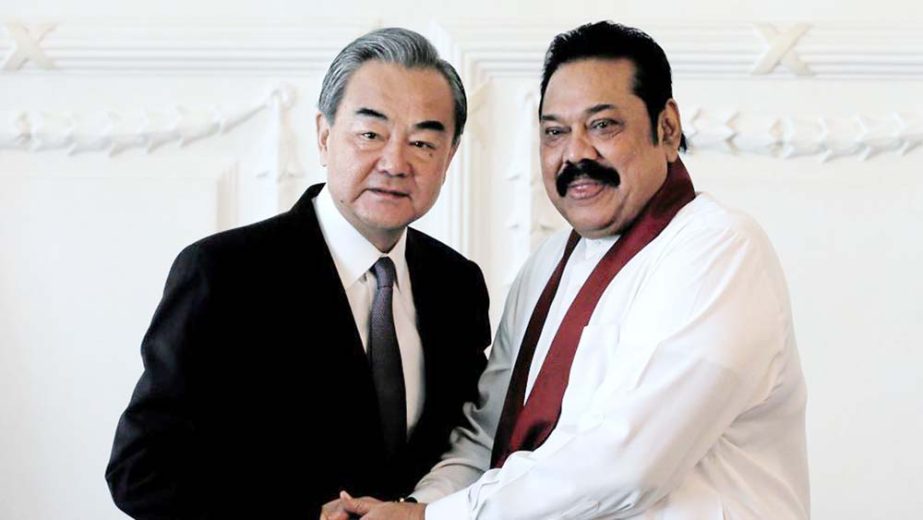 Chinese Foreign Minister Wang Yi shaking hands with Sri Lankan Prime Minister Mahinda Rajapaksa.