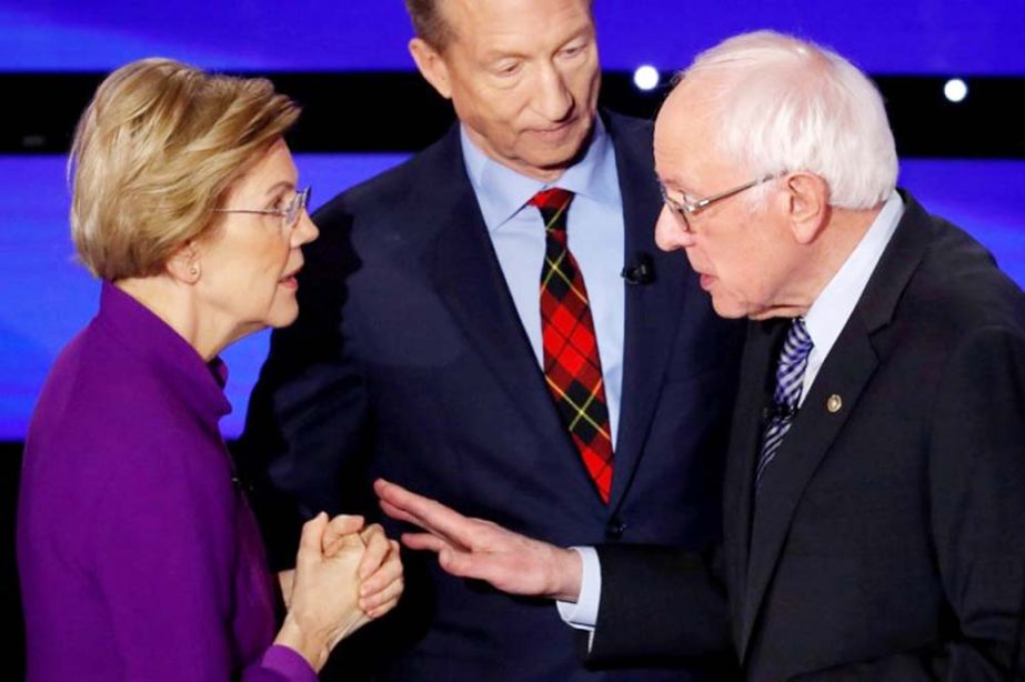 Democratic 2020 U.S. presidential candidates (L-R) Senator Elizabeth Warren (D-MA) speaks with Senator Bernie Sanders (I-VT) as billionaire activist Tom Steyer listens after the seventh Democratic 2020 presidential debate at Drake University in Des Moines