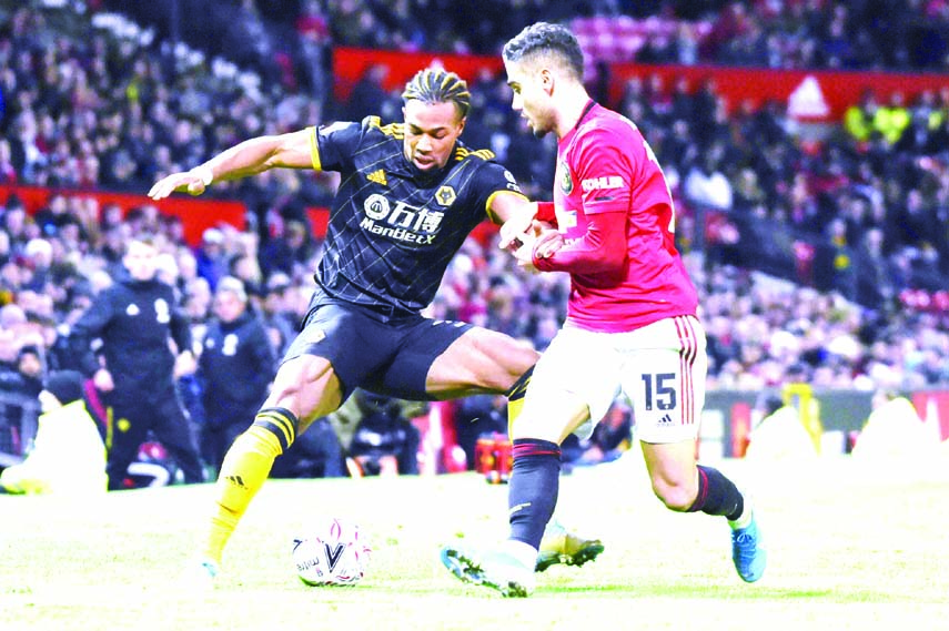 Wolverhampton Wanderers' Adama Traore ( left) and Manchester United's Andreas Pereira vie for the ball during the English FA Cup third round replay soccer match between Manchester United and Wolverhampton Wanderers at Old Trafford in Manchester of Engl