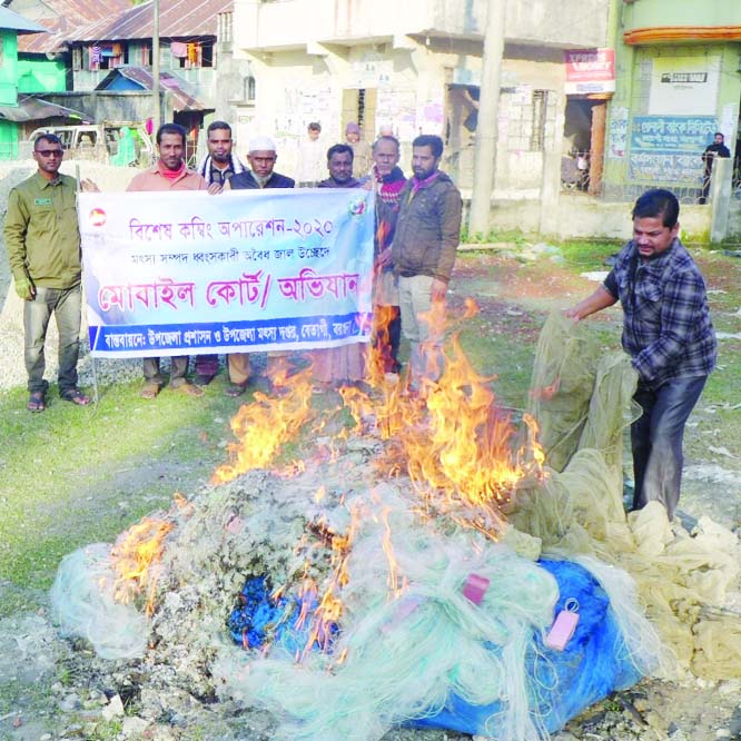 BETAGI (Barguna): Fisheries Department and Upazila Administration burning current nets seized in a special combing operation recently.
