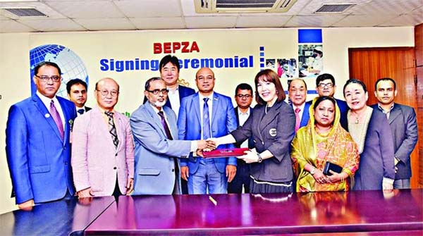 BEPZA Member (Investment Promotion) Zillur Rahman and Ms JW Apparel Ltd Managing Director Ji Won Oh exchanging documents of an agreement signed on behalf of their respective sides at the Bangladesh Export Processing Zones Authority (BEPZA) Complex recent